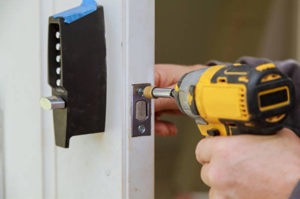 Builder is installing lock a doot in the room installation into wood door